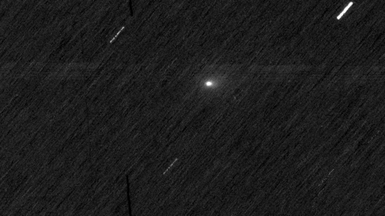 a bright white orb on a black, streaky background