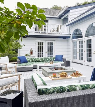 an outdoor seating area for a new england style home