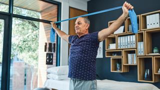 Man using resistance bands at home