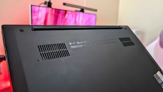 The Lenovo ThinkPad X1 Carbon (Gen 13) Aura Edition's rear panel, showing the dual fans and highlighting the laptop's name.