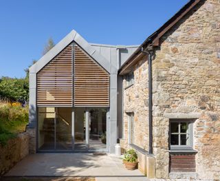 modern zinc clad extension to stone barn