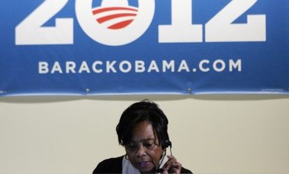A volunteer receptionist works the phones at President Obama's re-election headquarters in Chicago: Team Obama hardly seems confident that a 2012 victory is a sure thing.