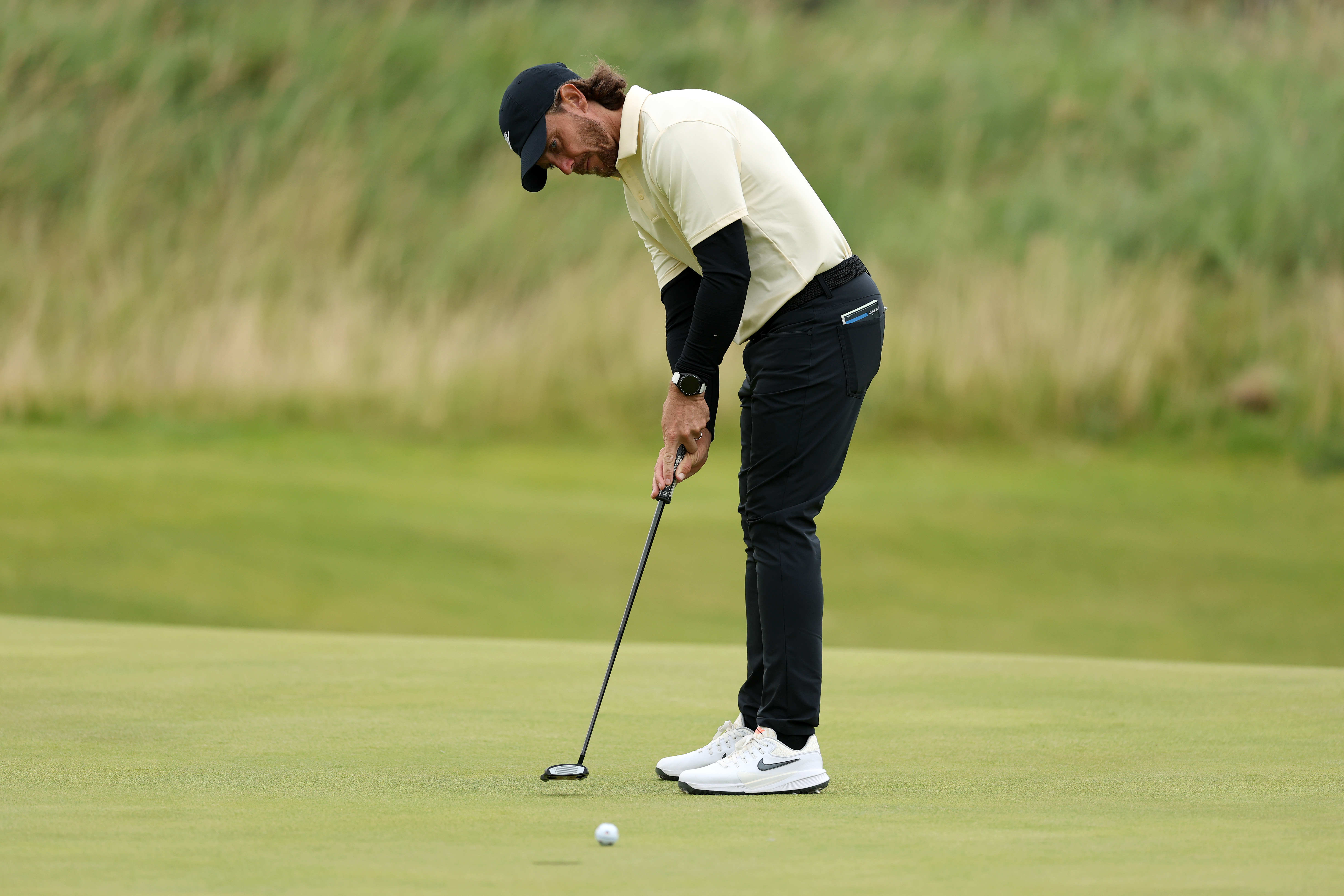 Tommy Fleetwood hits a putt