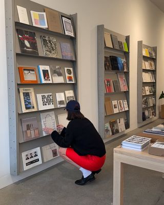 A photo of Jenner perusing coffee table books in a FWRD-sponsored photo dump shared to Instagram.