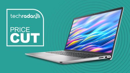 The Dell 15 Laptop on a green background next to a TechRadar badge that reads 'Price Cut'