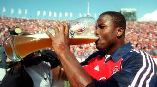 Sammy Kuffour of Bayern Munich drinks beer during the celebrations after winning the 1999/2000 Bundesliga title