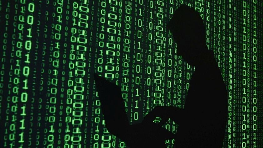 Illustration of the dark web showing a silhouette on a background of binary coding.