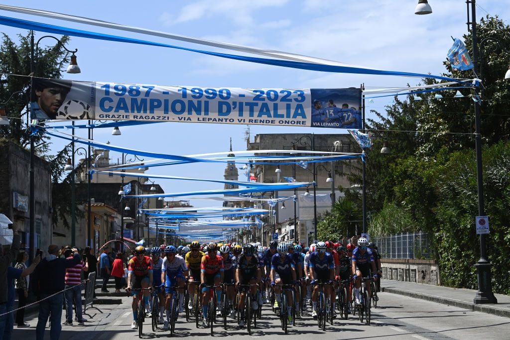 NAPLES ITALY MAY 11 A general view of the peloton passing through the streets of Naples decorated with the colors of the SSC Napoli football club as a celebration of it victory in the Italian league during the 106th Giro dItalia 2023 Stage 6 a 162km stage from Naples to Naples UCIWT on May 11 2023 in Naples Italy Photo by Tim de WaeleGetty Images