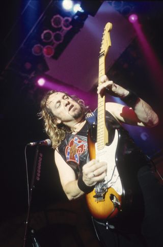Adrian Smith of Iron Maiden performing onstage