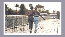 Two friends walking after a workout by the beach