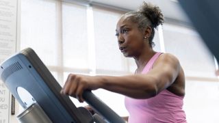 Woman exercising on cross trainer