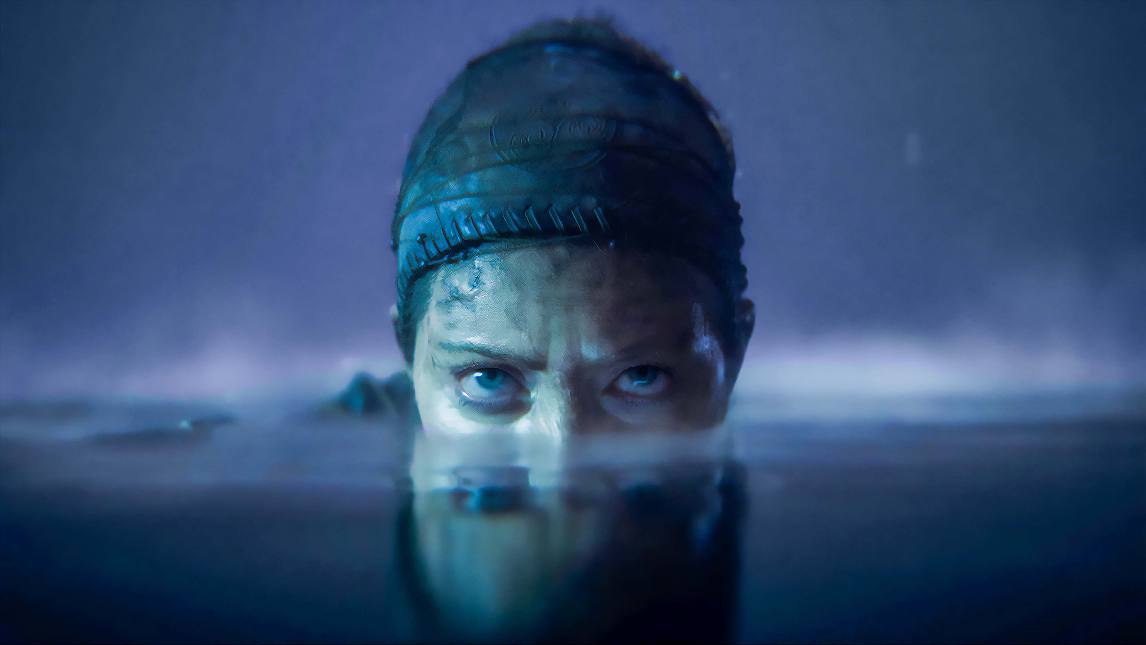 A screenshot from Senua&#039;s Saga: Hellblade 2 showing Senua&#039;s face half submerged in water.