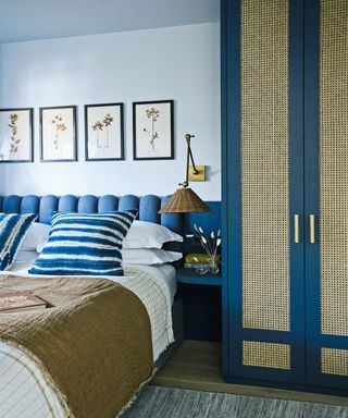 blue bedroom with blue scallopped headboard, blue wardrobe with rattan detailing