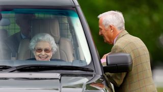 Queen Elizabeth II driving a car