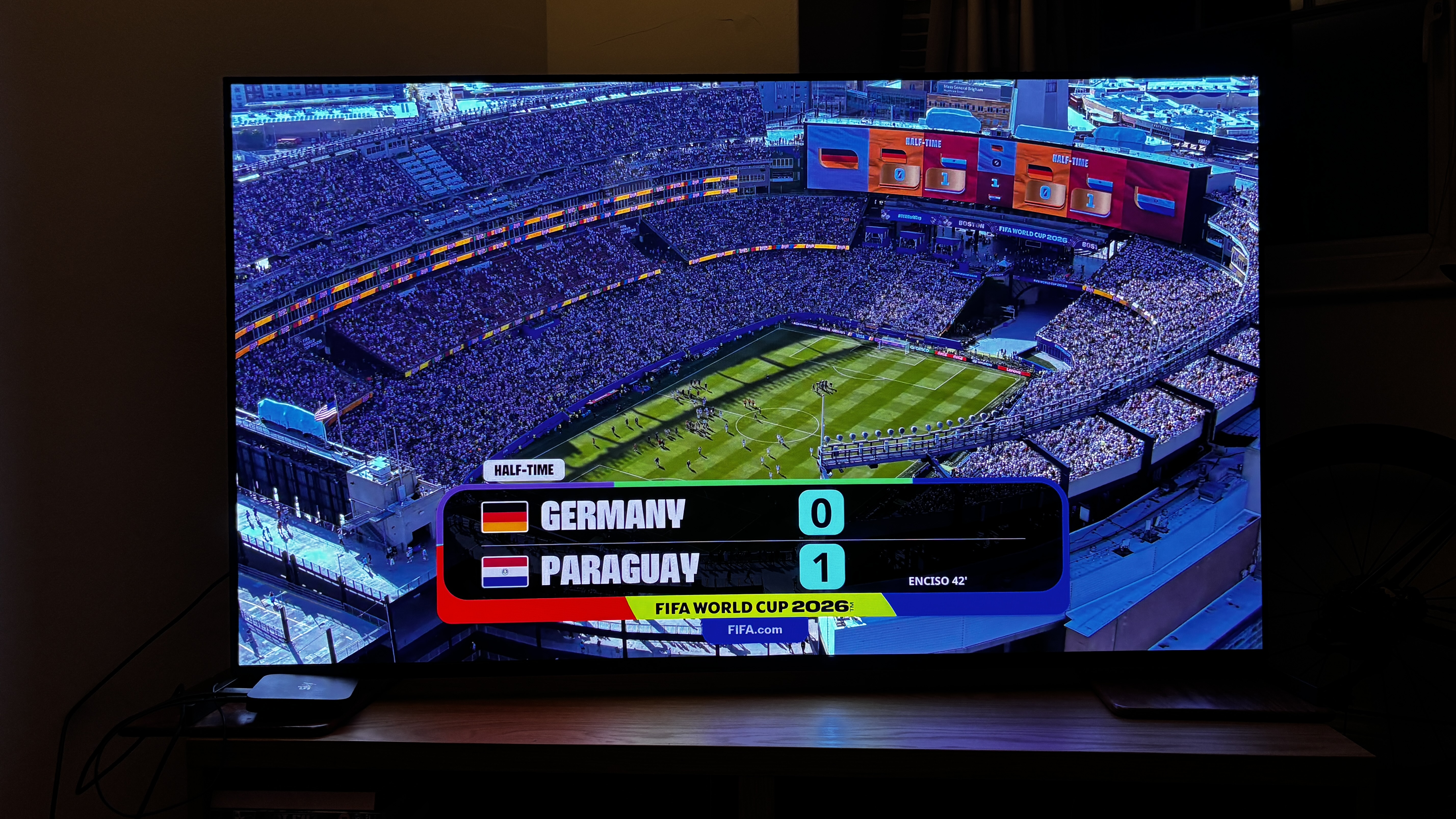 Aerial picture of a football stadium with a scoreline on the screen between Germany and Paraguay