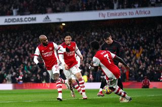 Arsenal’s Alexandre Lacazette (left) celebrates scoring their side’s first goal of the game with team-mates Takehiro Tomiyasu and Bukayo Saka during the Premier League match at the Emirates Stadium, London. Picture date: Saturday December 11, 2021