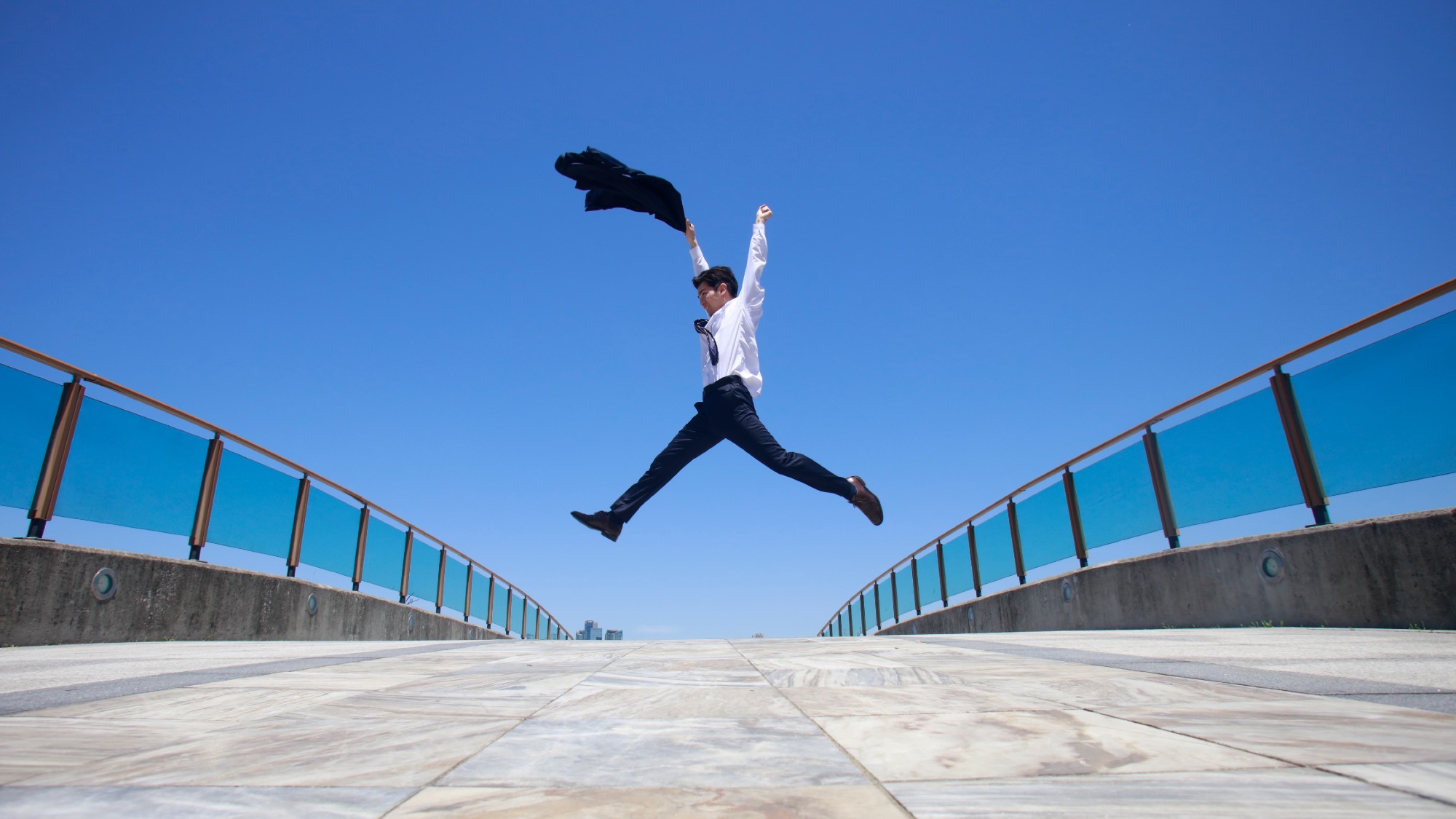 A Japanese businessman jumping into the air 