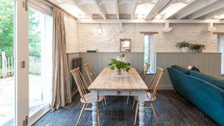white cottage with half wall panelling in dining room