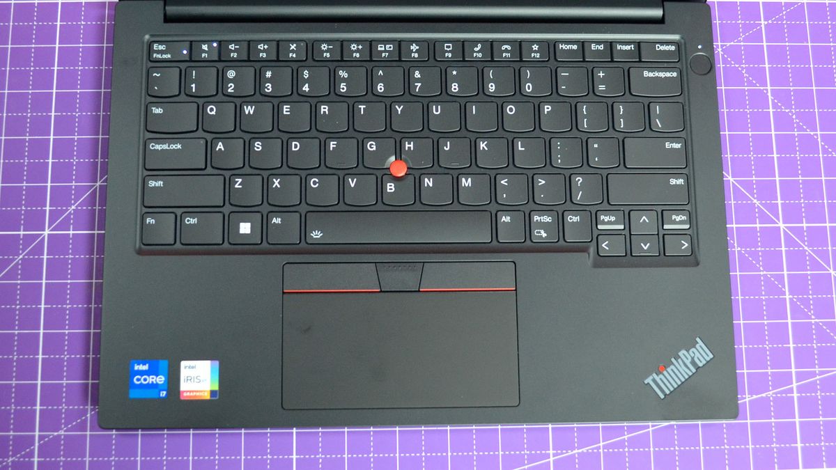 An Lenovo ThinkPad E14 Gen 5 on a purple deskmat