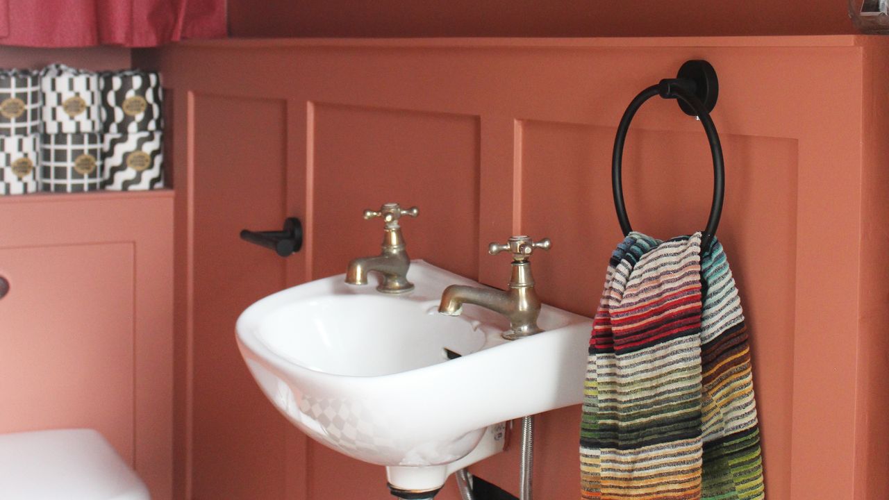 Terracotta painted small downstairs loo with DIY wall panelling