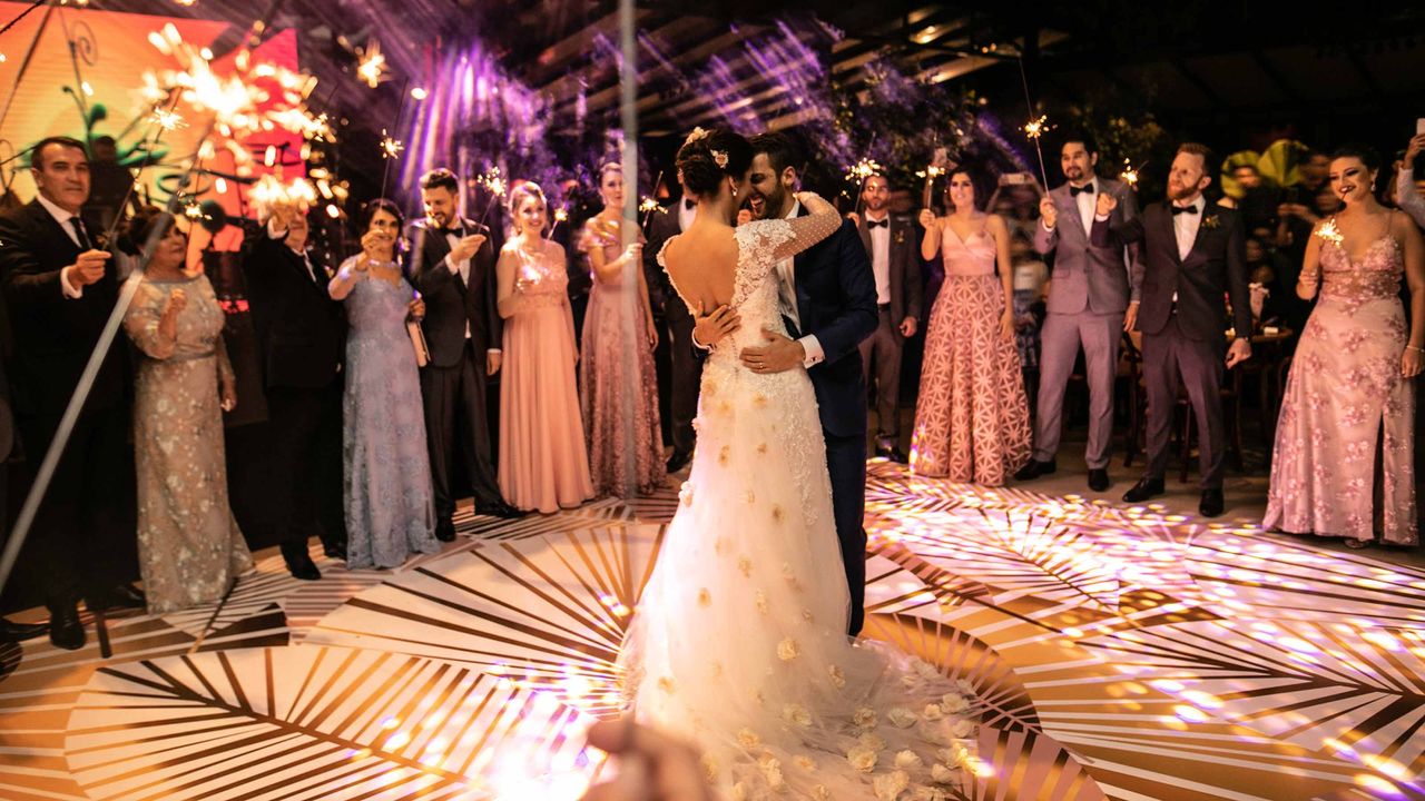 Wedding guests celebrate a newly married couple&amp;#039;s first dance