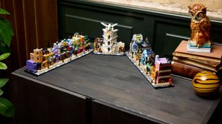 Lego Diagon Alley set on a wooden surface beside a china owl