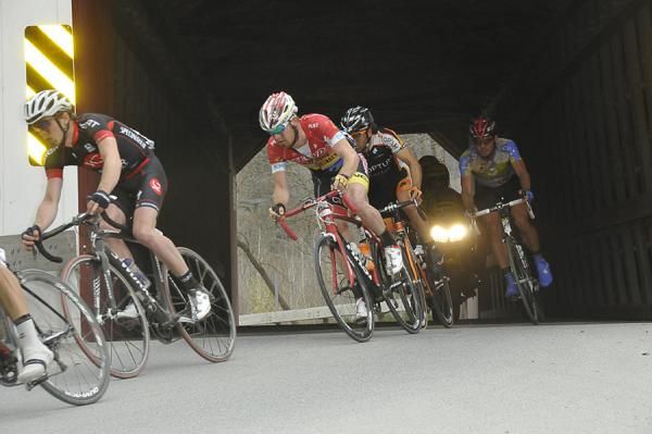 The lead group exits the Eagleville Covered Bridge on the second and final lap