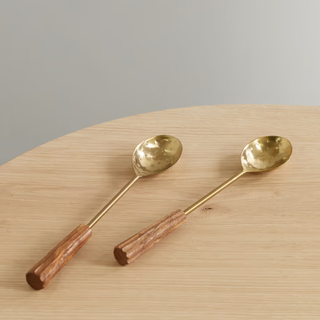 Gold serving spoons with wooden handles