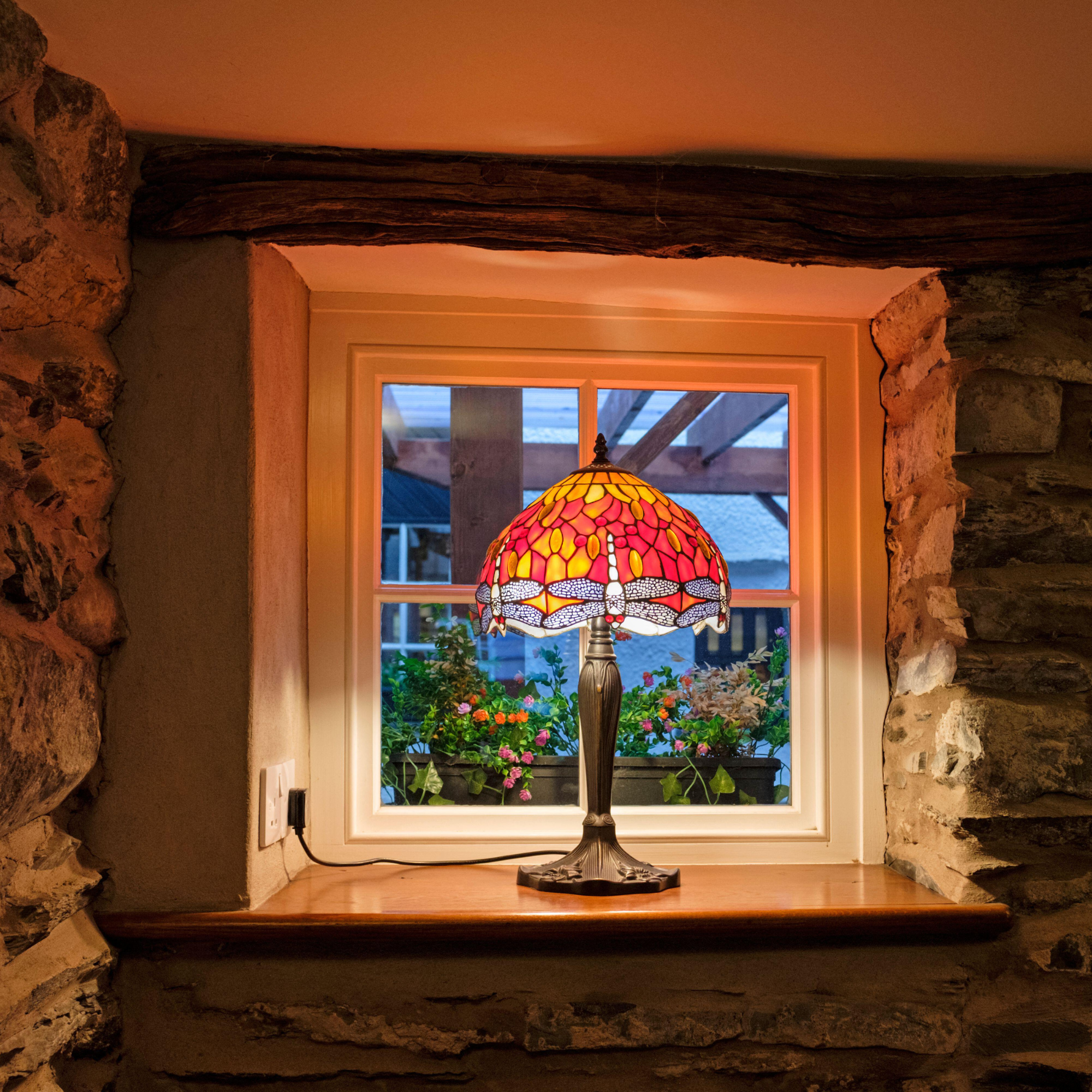 Tiffany lamp in windowsill.