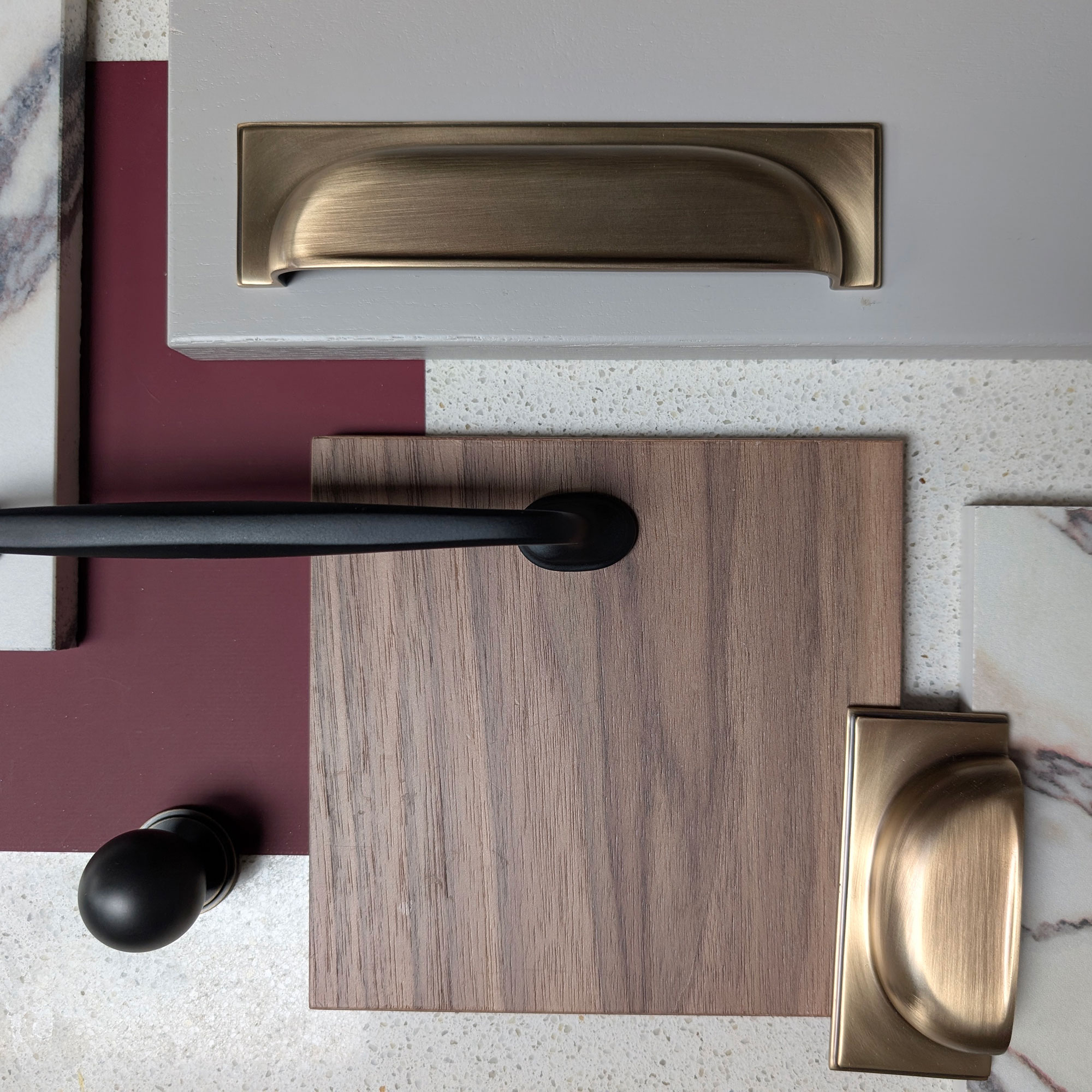 Flat lay of door pulls, handles, wood, paint and marble