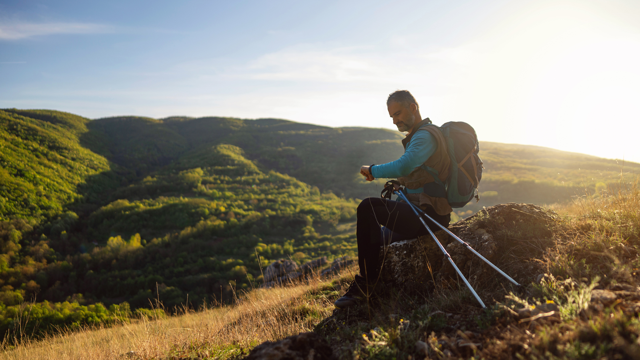 Hiker looks at watch