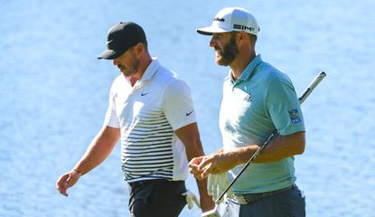 Koepka and DJ walk in front of the water