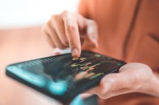 Woman investing in funds on a smartphone app