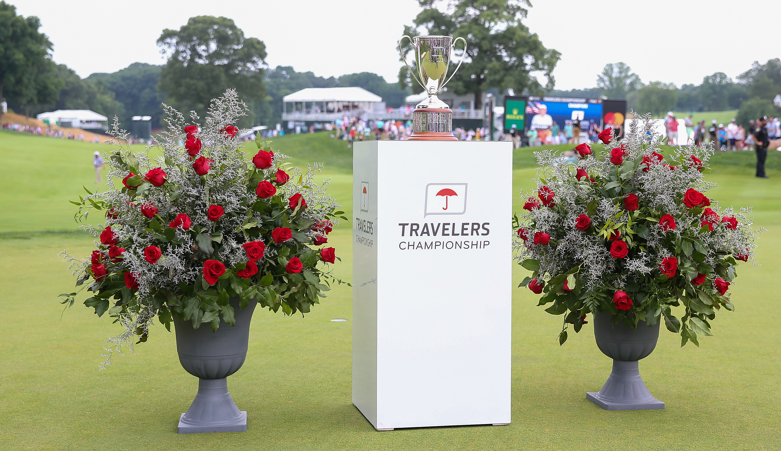 The Travelers Championship trophy next to a bed of flowers