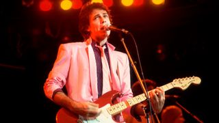Rick Springfield plays guitar as he performs onstage at the Mill Run Theater, Niles, Illinois, September 6, 1981.