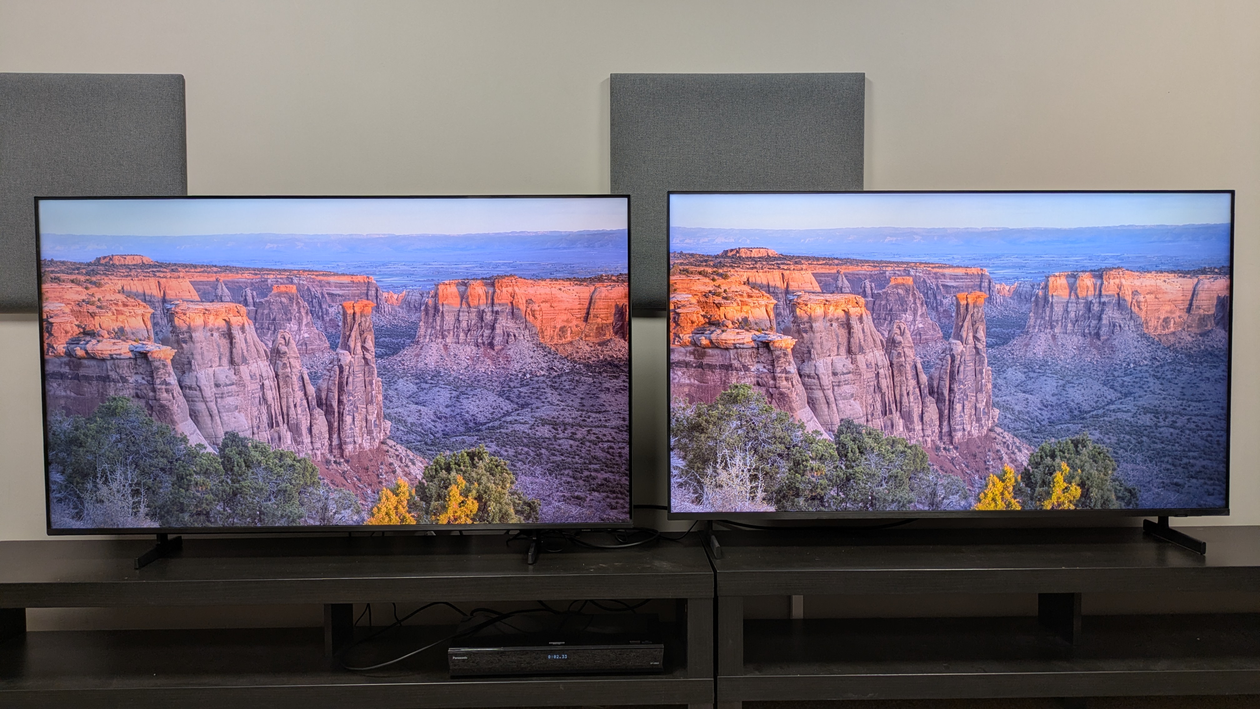 Samsung M80H (left) vs Samsung QN80H (right) showing a canyon at sunrise. The QN80H's highlight areas are brighter and textures are sharper