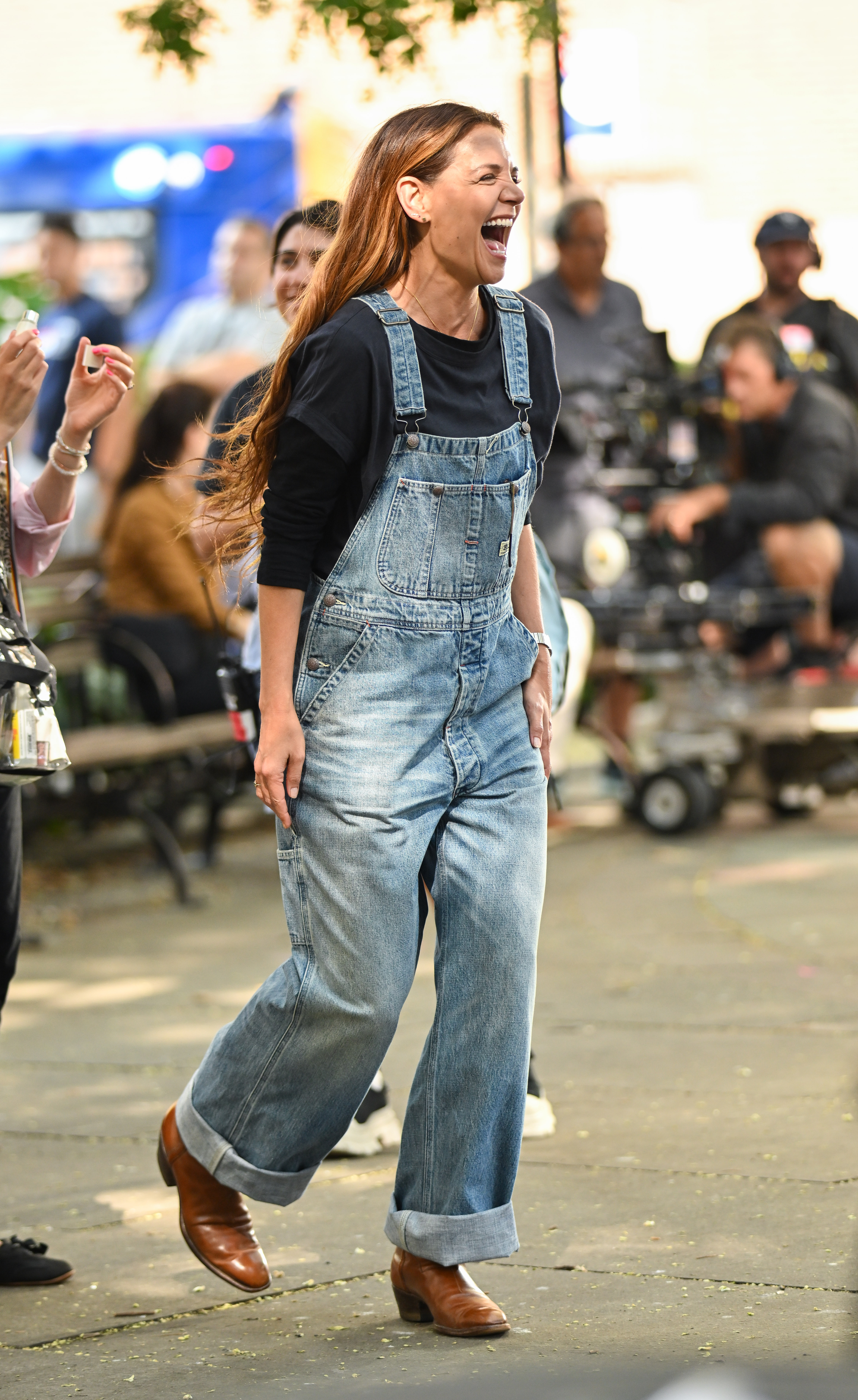 Katie Holmes wearing overalls with pointed toe boots