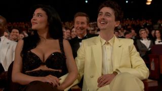 From left to right: Kylie Jenner looking up and to her left while holding Timothée Chalamet’s hand as he looks forward smiling at the 2025 Oscars. 