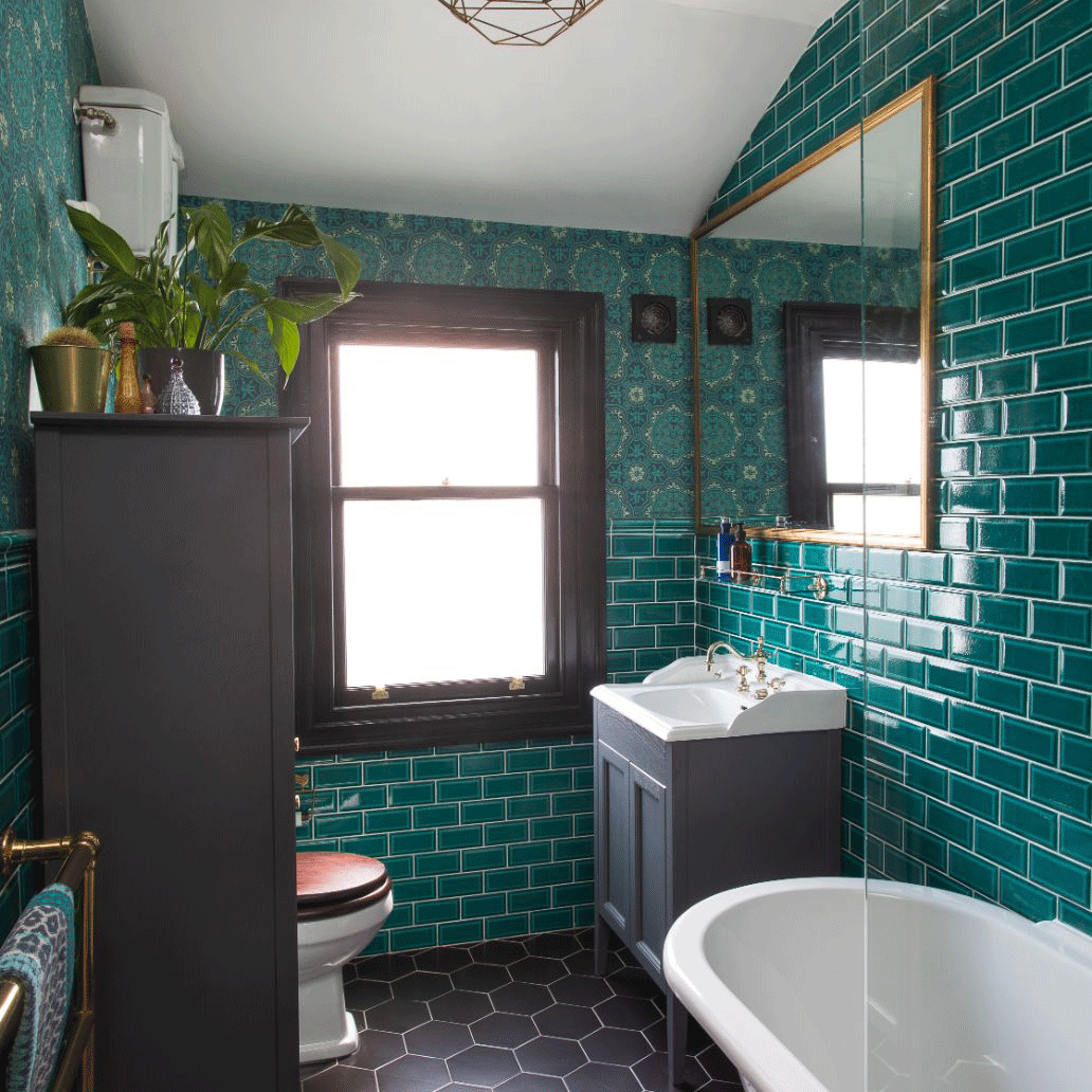 Bathroom with green wall tiles and grey cabinets