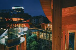 nighttime view from above of the Hans Christian Andersen House by Kengo Kuma