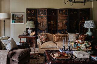 brown living room with tapestry on the wall