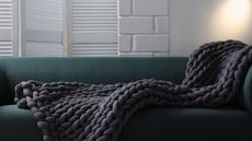 Dark gray knit blanket on sofa