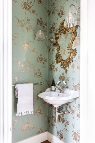 A downstairs toilet cloak room with blue and gold floral wallpaper