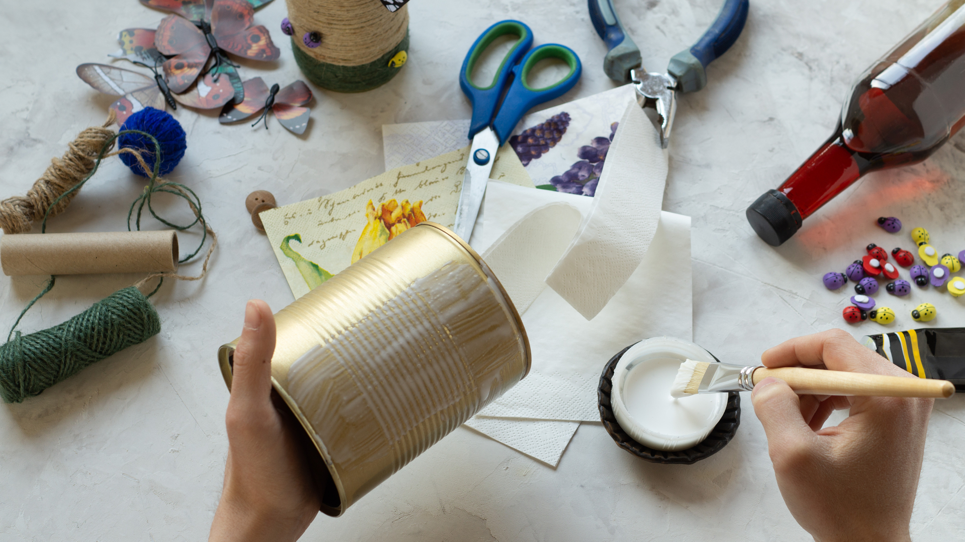 woman decorating a tin can at home during a craft session