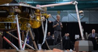 Bruce Banerdt, pictured standing with the microphone, at InSight's pre-launch media briefing at Vandenberg Air Force Base in California on 3rd May 2018. A model of the InSight lander can be seen in the foreground.