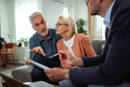 Mature couple talking to a financial advisor 