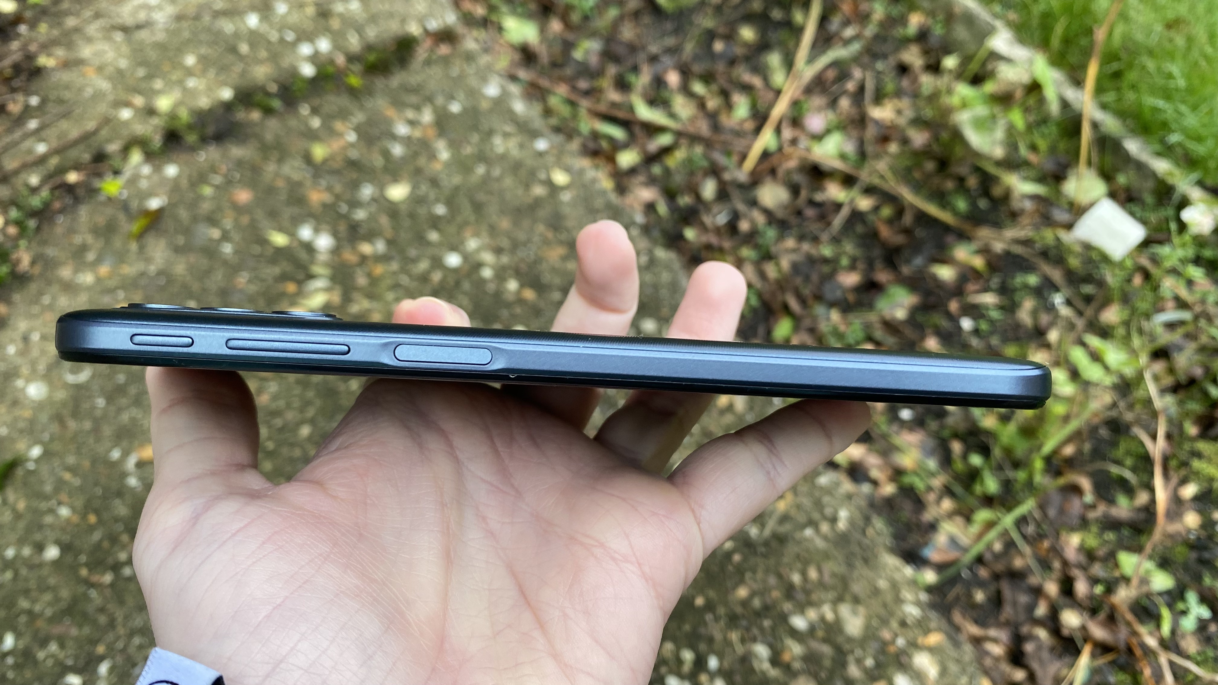 A Moto G31 from the side, in someone's hand