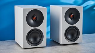 the cambridge audio l/r s bookshelf speakers in white with a 21mm aluminum tweeter and a 3-inch woofer photographed against the blue tom's guide background
