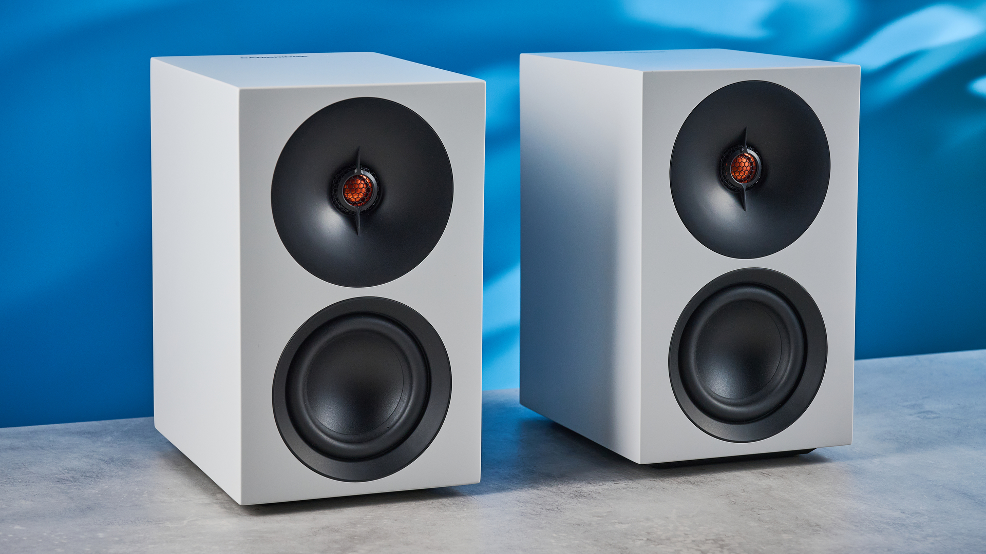 the cambridge audio l/r s bookshelf speakers in white with a 21mm aluminum tweeter and a 3-inch woofer photographed against the blue tom's guide background