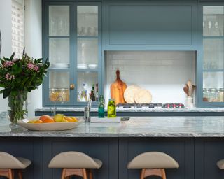 blue kitchen with island and chopping boards